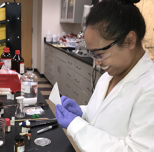 Dr. Janice Sindac, a medicinal chemist at Tetra working at a lab bench